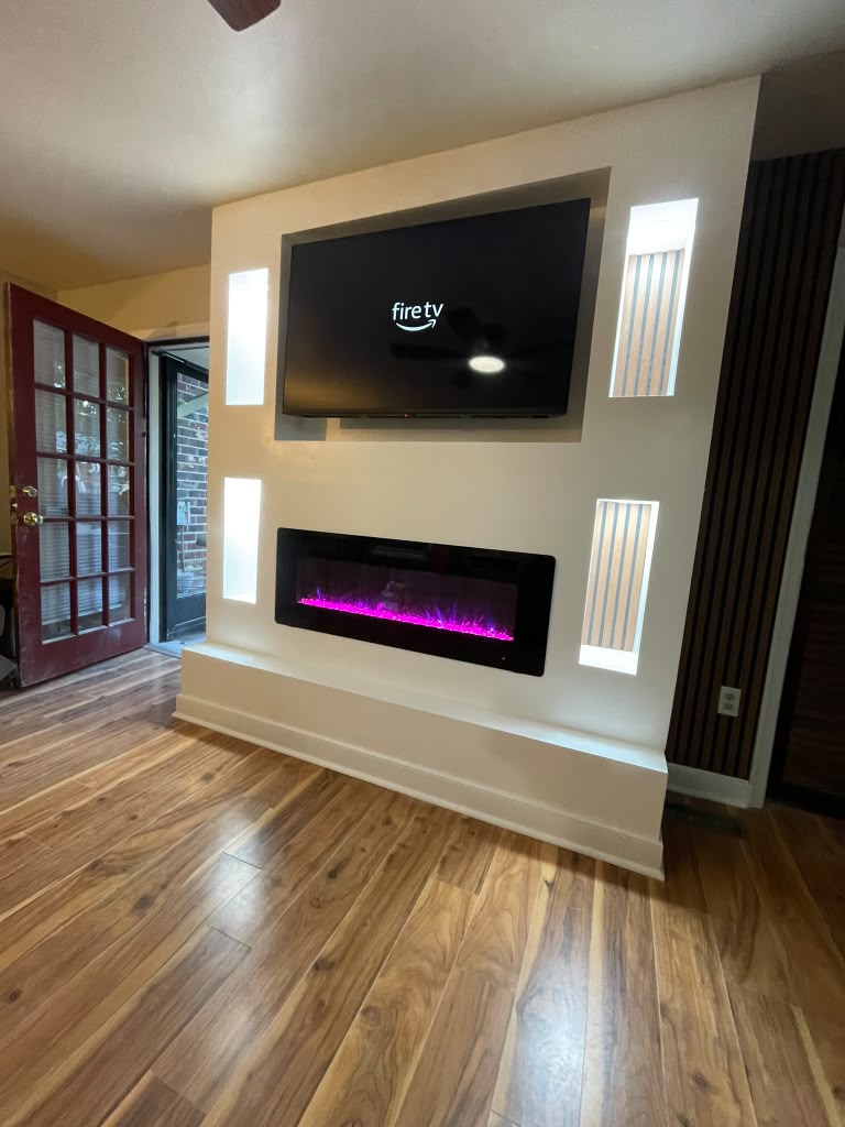 Living room renovation with custom fireplace and TV wall